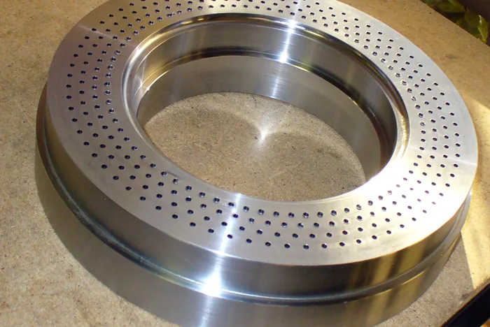 Machined stainless ring with a drilled hole pattern